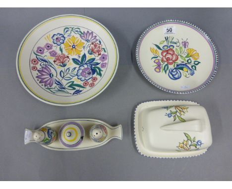 Four items of Art Deco style Poole Pottery to include shallow bowl, plate, cruet set and butter dish
