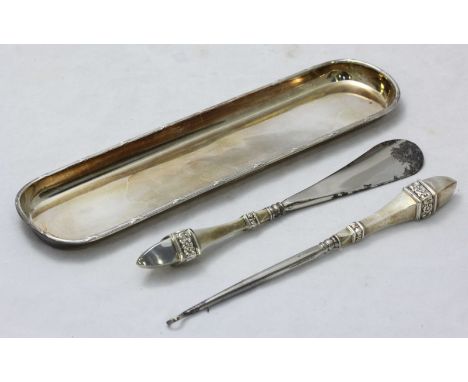A small Edwardian silver pen tray, hallmarked Chester 1908, together with a stainless button hook and shoe horn, both with si