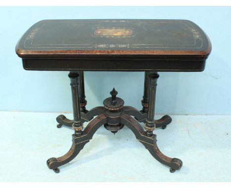 A Victorian ebonised folding card table, the inlaid top lifting to reveal a brown felt playing baize with gilt-tooled leather