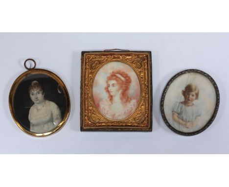 Two 19th century oval portrait miniatures of ladies, one in ornate gilt metal frame with tooled leather back, together with a