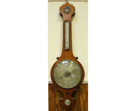 A late 19th century stained oak veneered mercury wheel barometer by W M Corke of Wolverhampton, with hygrometer, thermometer,