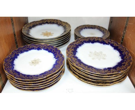 SECTION 27. 25 assorted 'Limoges' porcelain plates and bowls, decorated with a blue and gilt design.