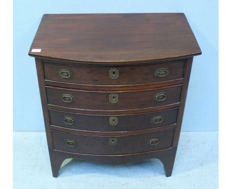 A small mahogany bow-front chest of four long graduated drawers, with shaped apron and raised on shaped bracket feet. 60cm wi