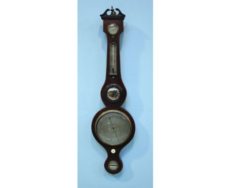 An Edwardian mercury wheel barometer with thermometer, hygrometer, small convex mirror and leveling feature, stained mahogany