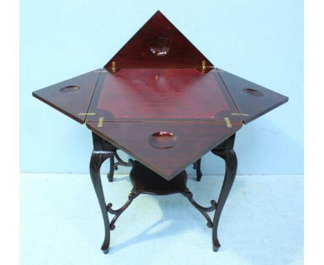 A stained mahogany folding card table enclosing red leather lining, with single frieze drawer, under-tier and raised on cabri