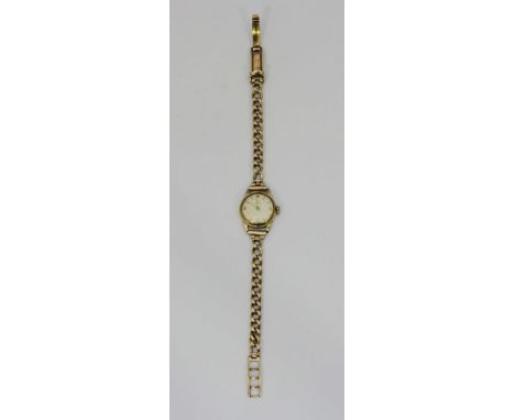 A ladies 9ct gold Tissot cocktail watch, the silvered dial with batons denoting hours and Arabic numerals at the 3, 6, 9 and 