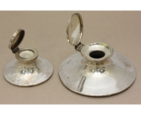 A silver capstan inkwell stamped Birmingham 1910, lacking liner, 13cm wide, together with another smaller capstan inkwell, gr