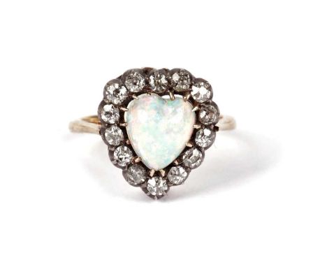 A Victorian opal and diamond heart-shaped ring, the heart-shaped opal cabochon surrounded by fourteen old-cut diamonds, in si