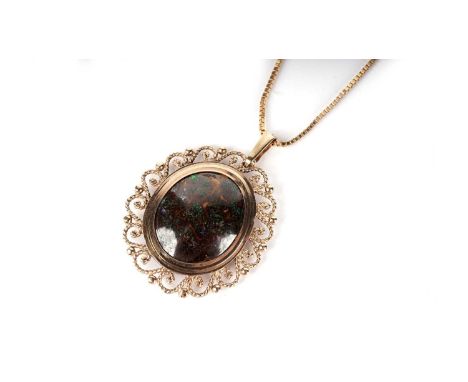 A black boulder opal pendant, the cabochon 18.3 x 13.7mm in 9ct yellow gold scrolling mount, on 9ct yellow gold box link chai