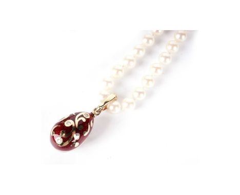 Faberge: an 18ct yellow gold, red enamel and diamond egg-pattern pendant, of scrolling design, limited edition 639/1000, with