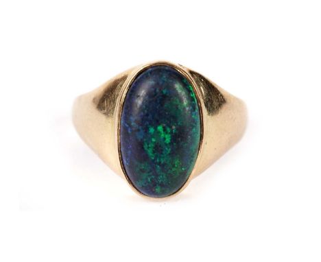 A black opal ring, the oval opal cabochon measuring 14.8 x 9.0mm, collect set in 18ct yellow gold mount and shank, ring size 