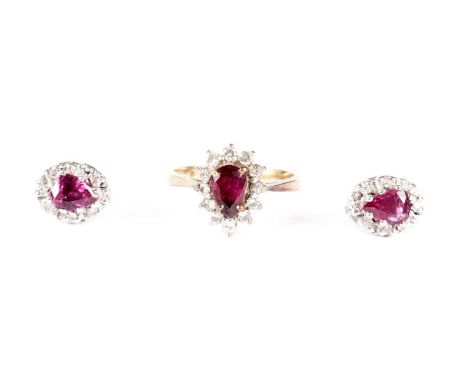 A ruby and diamond cluster ring and matching earrings, each centred by pear-cut ruby surrounded by brilliant-cut diamonds, in