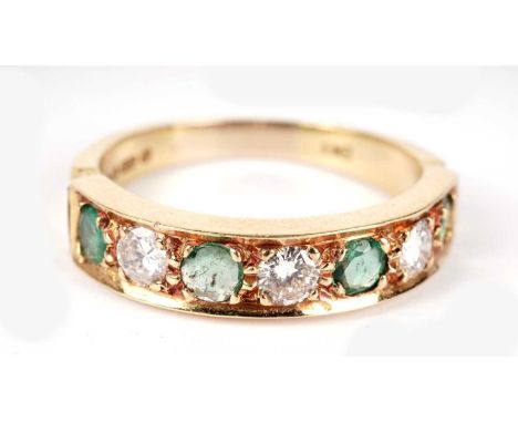 An emerald and diamond ring, the four circular facet-cut emeralds parted by three brilliant cut diamonds weighing a total of 