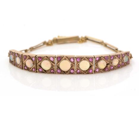 An opal and ruby bracelet, the graduated links set with circular opal cabochons and facet cut rubies, in yellow gold mount, t