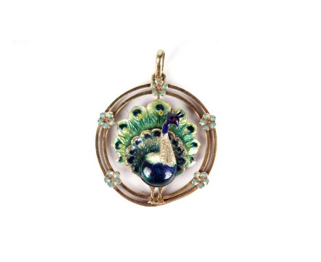 A late 19th Century peacock pattern pendant, polychrome enamel on 15ct yellow gold, standing in a flower decorated ring, 33mm