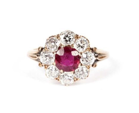 A ruby and diamond cluster ring, the central circular facet-cut ruby surrounded by eight old-cut diamonds weighing a total of