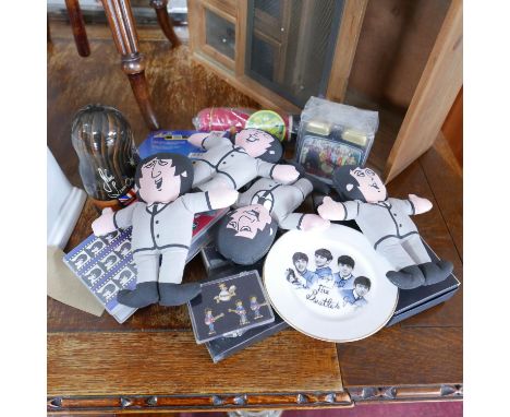 A collection of Beatles memorabilia to include a babushka doll, 4 soft dolls, 2 VHS videos, an alarm clock, a plate, pack of 