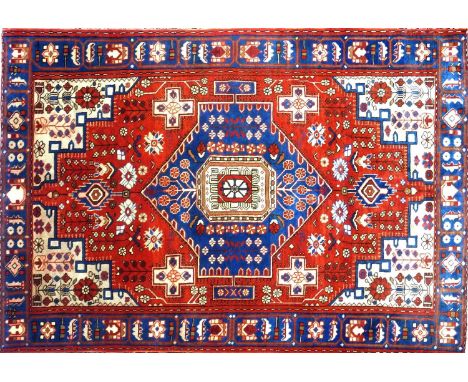 A North West Persian Nahawand rug, central diamond medallion with repeating geometric motifs on a terracotta field within sty