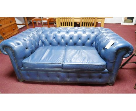 A blue leather Chesterfield sofa 