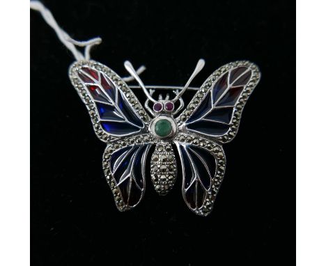 A large sterling silver butterfly brooch, set with marcasites, plique-à-jour enamel wings, emerald abdomen and ruby eyes, 4.5