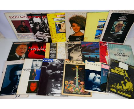 A collection of books and ephemera relating to music / musicians to include The Beatles, Jason Donovan, Oasis, Madonna, Level