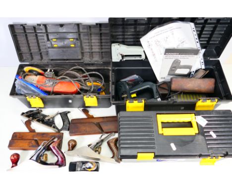 Three tool boxes containing a quantity of tools to include electric stapler, Black & Decker CD115 Angle Grinder, planes and s