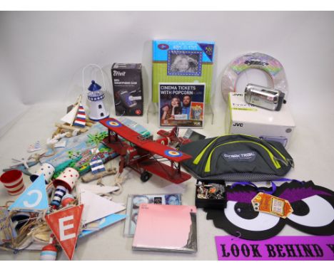 A mixed lot to include: A shrink wrapped "Buyagift - Cinema Tickets with popcorn", an Ozark trail waist tag new with tags, A 