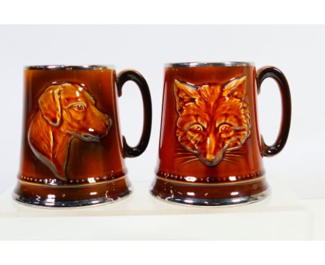 Sylvac - Two hunting themed tankards / mugs, 2375 and 2376 one decorated with a moulded fox mask, the other with a fox hound,