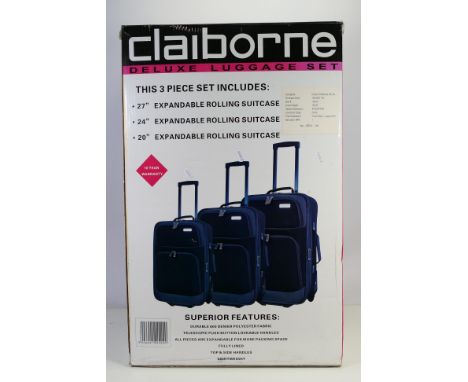 A boxed three piece luggage set by Claiborne comprising a 20" expandable rolling suitcase, a 24" and a 27". [W]