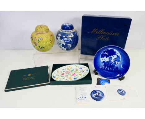 Lot comprising two ginger jars and covers, one decorated with prunus in blue and white with vacant double circle to the base,