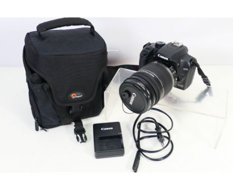 Photography - A Canon EOS 1000D camera with attached EF-S 18-200mm 1:3.5-5.6 lens, contained in camera bag. [W]
