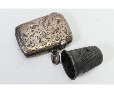 A small late Victorian silver vesta case, Birmingham assay 1894 and a silver thimble. [W]