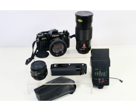 Photography - A Canon AE1 camera with attached Canon 1:1.8 50mm lens, additional lenses and accessories. [W]
