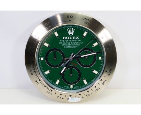 A clock / watch dealers advertising display wall clock, green dial with baton hours, three subsidiary dials, 33.5 cm (d). [W]