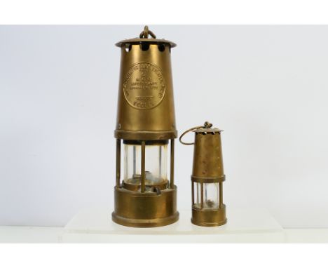 A Protector Lamp & Lighting Co Ltd Type 6 Safety Lamp, 25 cm (h) and a smaller unmarked example. [2]. [W]