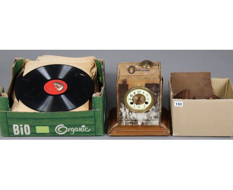 An early 20th century mantel clock, 24cm high, w.a.f.; together with a wrought-iron wall-mounted lamp; &amp; various records.