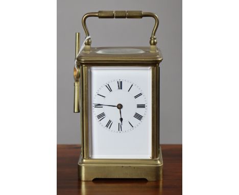 A French brass-cased carriage clock with an eight-day movement, &amp; with black roman numerals to the white enamel dial, 14c