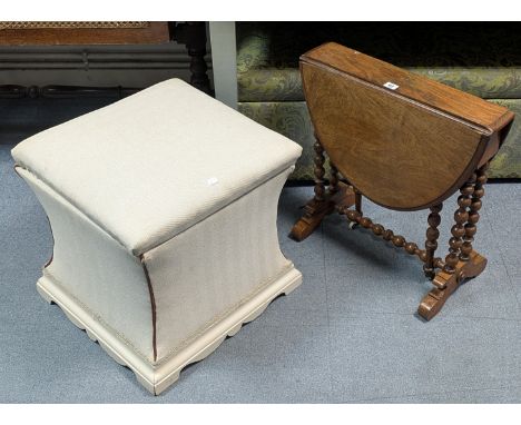A late 19th/early 20th century walnut oval drop-leaf occasional table on bobbin-turned supports &amp; scroll feet joined by a