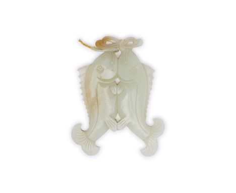 A Chinese pale green jade ‘twin-fish’ pendant20th centuryCarved inform of two conjoined fishes below a bow, the stone of pale