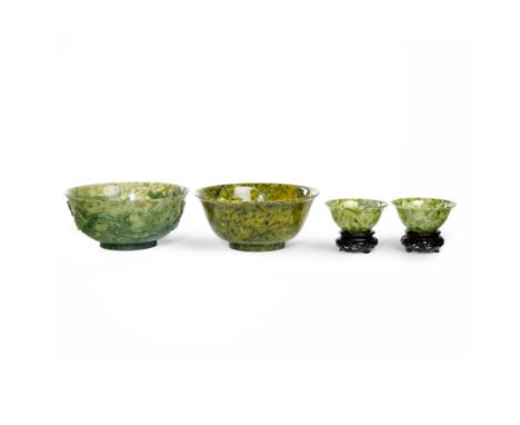 Three Chinese spinach hardstone and one carved spinach jade bowl20th centuryComprising: a small hardstone pair, each 10.3cm d