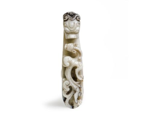 A Chinese pale jade 'dragon' belt hookQing dynasty, 18th/19th centuryTypically carved with dragon head-hook confronting a hig