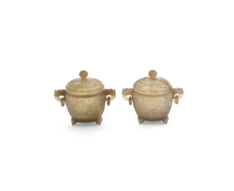 A pair of Chinese agate tripod handled bowls and coversLate Qing dynastyThe bowls carved in shallow relief with a lotus pond 