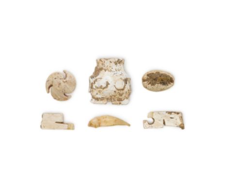 Three Chinese hardstone carvings, a shell and a toothNeolithic periodThe hard stones carved with an animal mask, a button wit