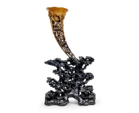 A Chinese full-tip rhinoceros horn libation cupQing dynasty, 19th centuryIntricately carved with lotus pods and flowers, mill