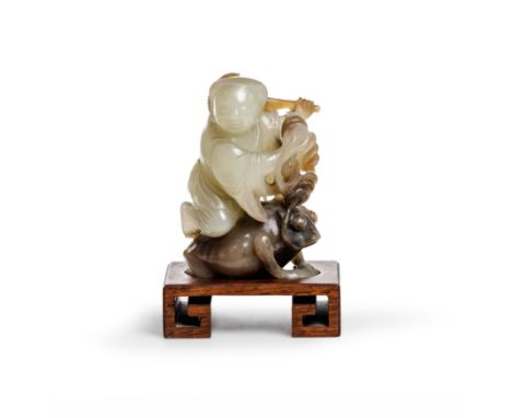 A Chinese two colour jade carving of Liu Hai and his three-legged toadQing dynasty, Jiaqing periodCarved with the figure hold