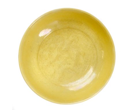 A Chinese yellow glazed 'dragon' dishQing dynasty, Daoguang mark and periodThe deep dish with gently rounded sides rising fro