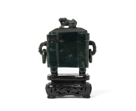 A Chinese green hardstone incense burner and coverLate Qing/Republic periodOf rectangular form raised on scroll feet, flanked