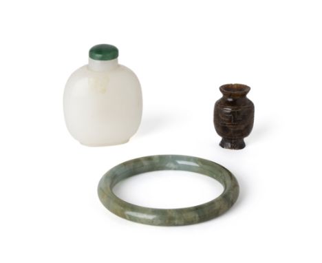 A Chinese green jade bangle and two snuff bottles19th - 20th centuryComprising a green jade bangle with russet and creamy clo