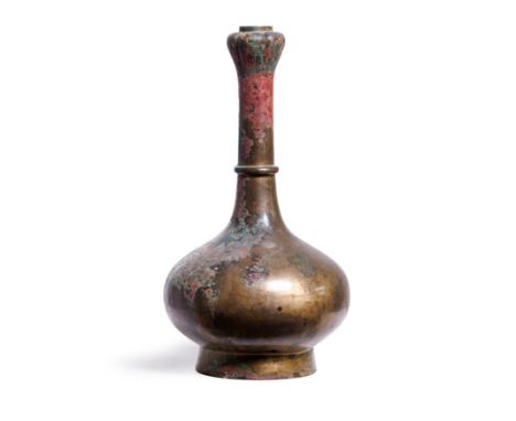 A Chinese archaic bronze garlic mouth wine vessel, suantoupingHan dynastyThe compressed globular body raised on tall slightly