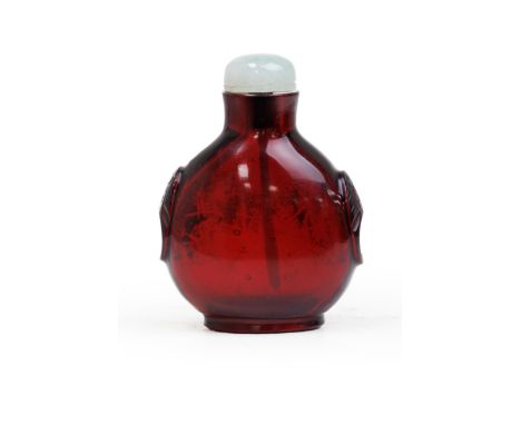 A Chinese ruby glass snuff bottleQing dynasty, 19th centuryCarved with paired animal-mask-and-ring handles, jadeite stopper w